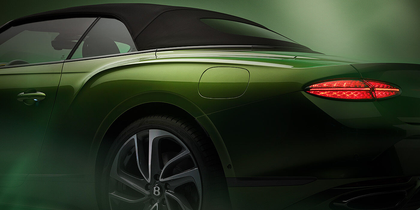 Bentley Oslo Bentley New Continental GTC Speed rear haunch and tail lamp in Tourmaline Green paint and dark tint brightware with black hood up and illuminated head lamps