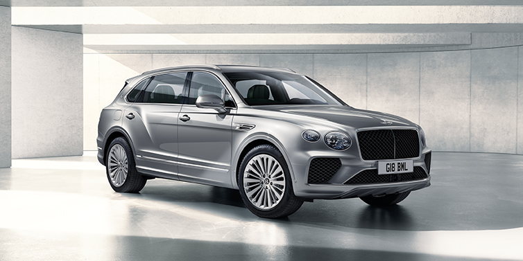 Bentley Oslo Bentley Bentayga Extended Wheelbase SUV front three quarter in Moonbeam paint with a grey background