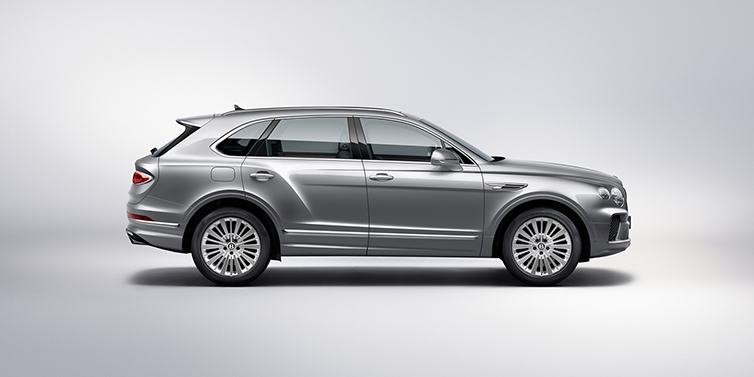 Bentley Oslo Bentley Bentayga SUV side profile in Moonbeam silver paint against white background featuring 21 inch 5 spoke wheels